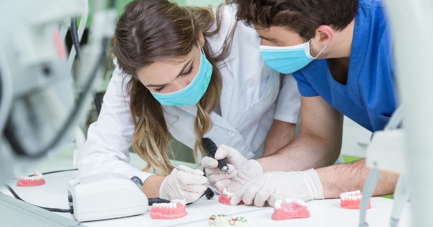 people working together on dentures in dental lab