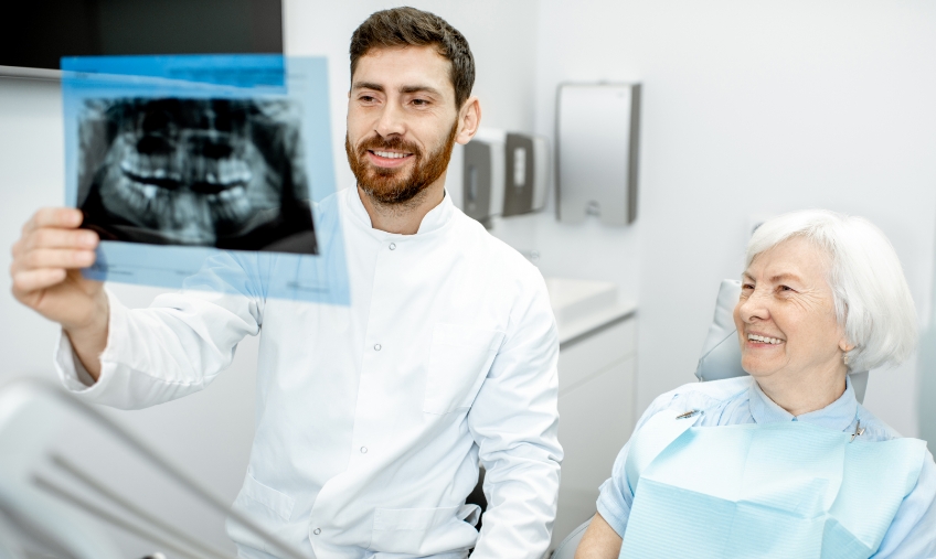 Dentist with senior patient