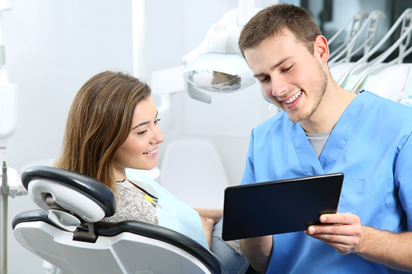 hygienist going over patient chart
