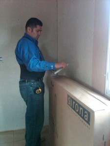 A man opening a large box.